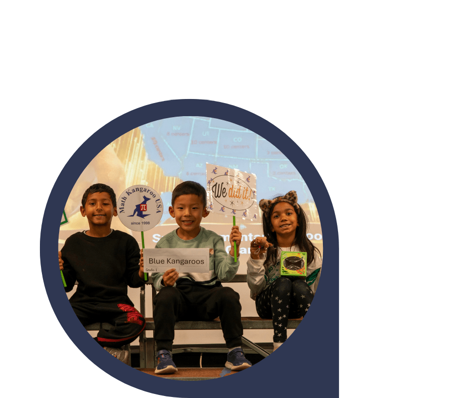 Three smiling children hold project signs such as 'Blue Kangaroos' and 'We did it!' at a classroom presentation, circle-cropped image with a dark blue border.
